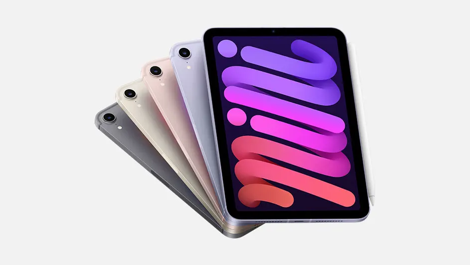 Vijf iPads in verschillende kleuren, gerangschikt op een witte achtergrond. De scherm van de eerste iPad toont paarse en roze tinten.