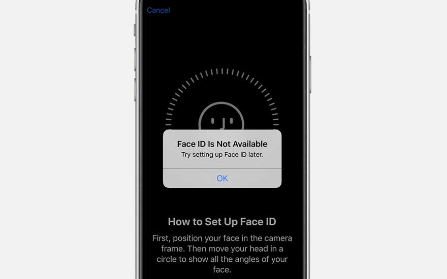 Zilveren smartphone met zwarte achtergrond waarop 'Face ID niet beschikbaar' staat. Instructies voor het instellen van Face ID worden weergegeven.