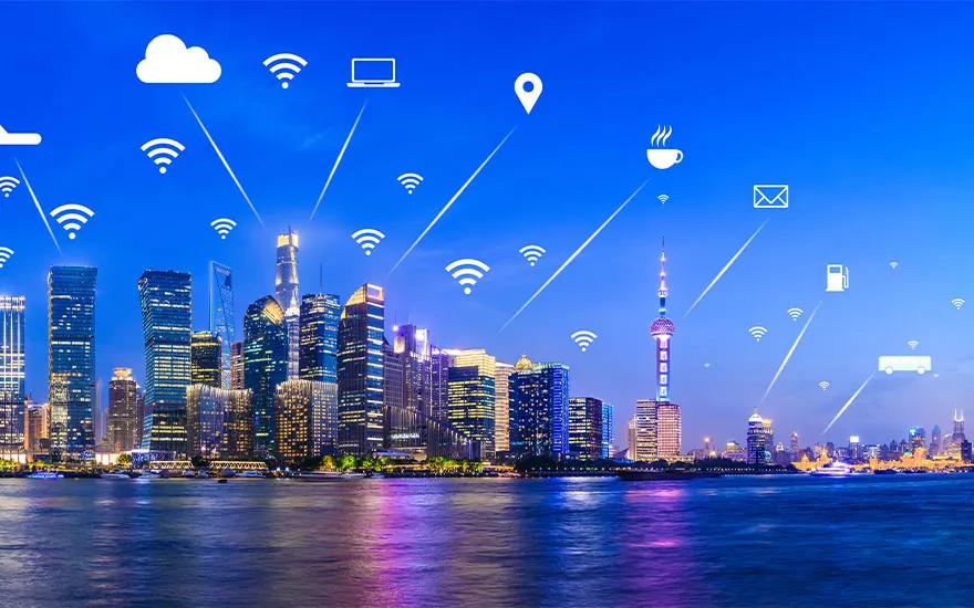 Horizon urbain nocturne illuminé avec des icônes de connectivité sur un ciel bleu au-dessus d'une étendue d'eau.