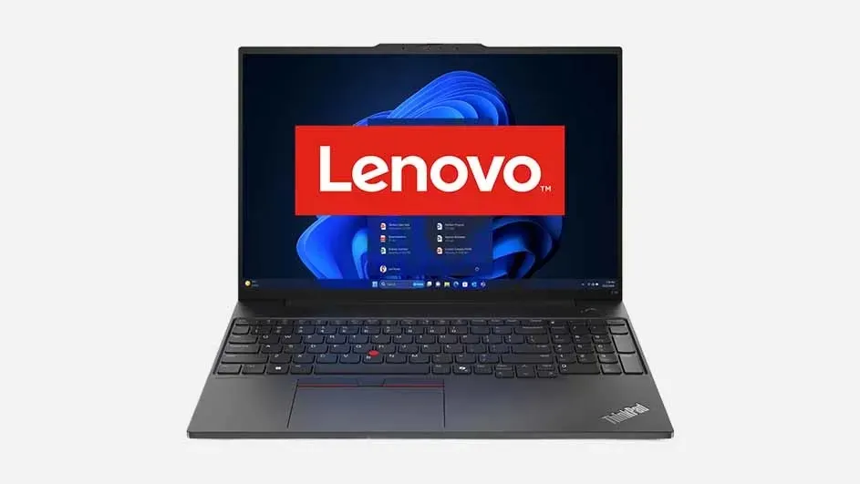 A grey Lenovo ThinkPad laptop displaying the Lenovo logo on screen with a blue Windows desktop background visible.