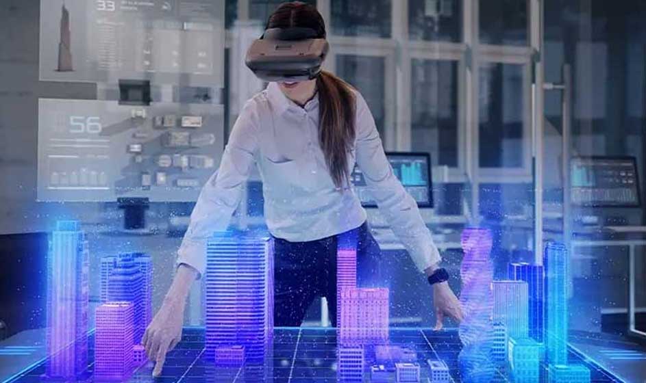 Image d'une table avec des bâtiments virtuels bleus et violets. Une personne porte un casque VR. Des écrans sont visibles en arrière-plan.