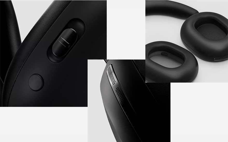 Zwart koptelefoon detailopname toont oorkussens, schuifregelaar, knop en ventilatieopeningen op een witte achtergrond.