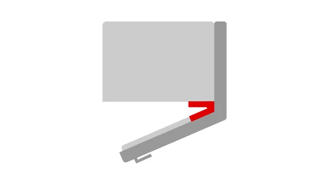 Vue d'un coin de table gris avec un renfort rouge en forme de V et une pièce de fixation gris clair.