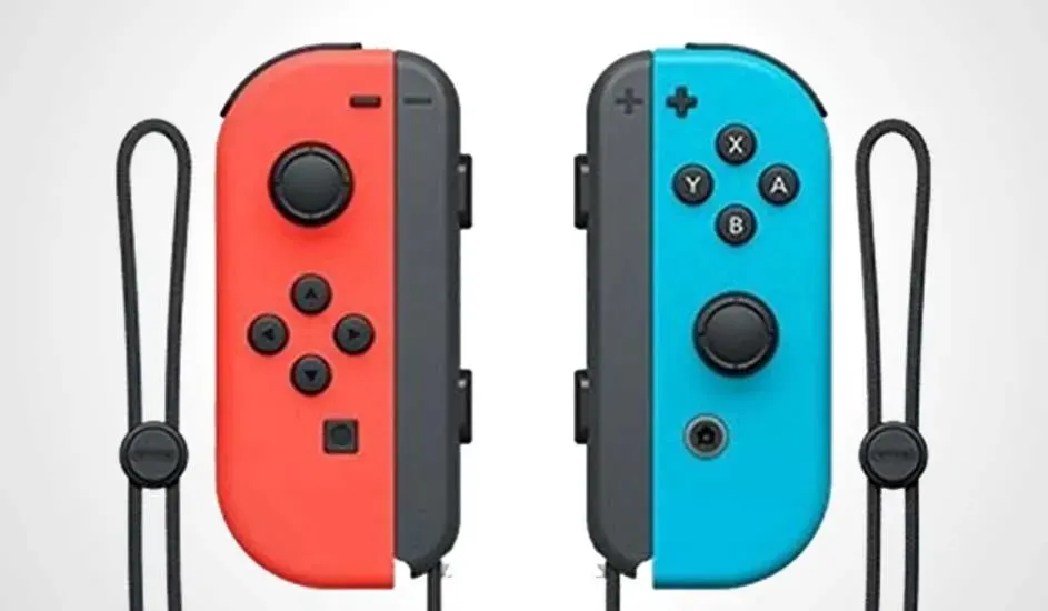 Two Nintendo Switch Joy-Cons, one red, one blue, both with black buttons and wrist straps on a white background.