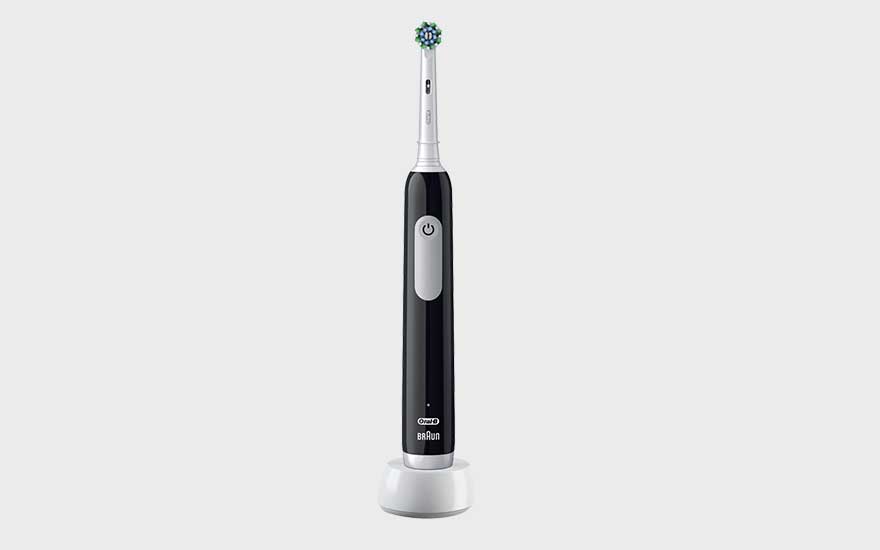 A silver electric toothbrush with display, travel case, two brush heads and a charger are neatly arranged