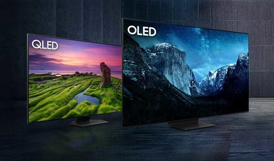 Two televisions stand side by side: left a QLED with a vivid landscape, right an OLED with a dark mountain scene at night.