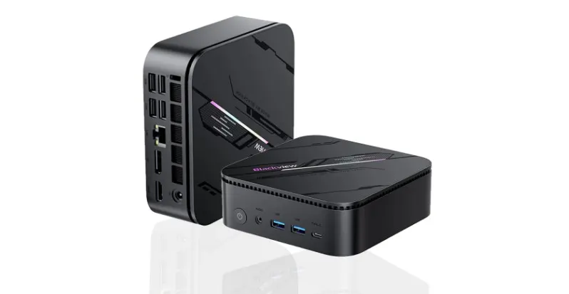Mini PC negro compacto con diseño moderno y múltiples puertos de conexión.
