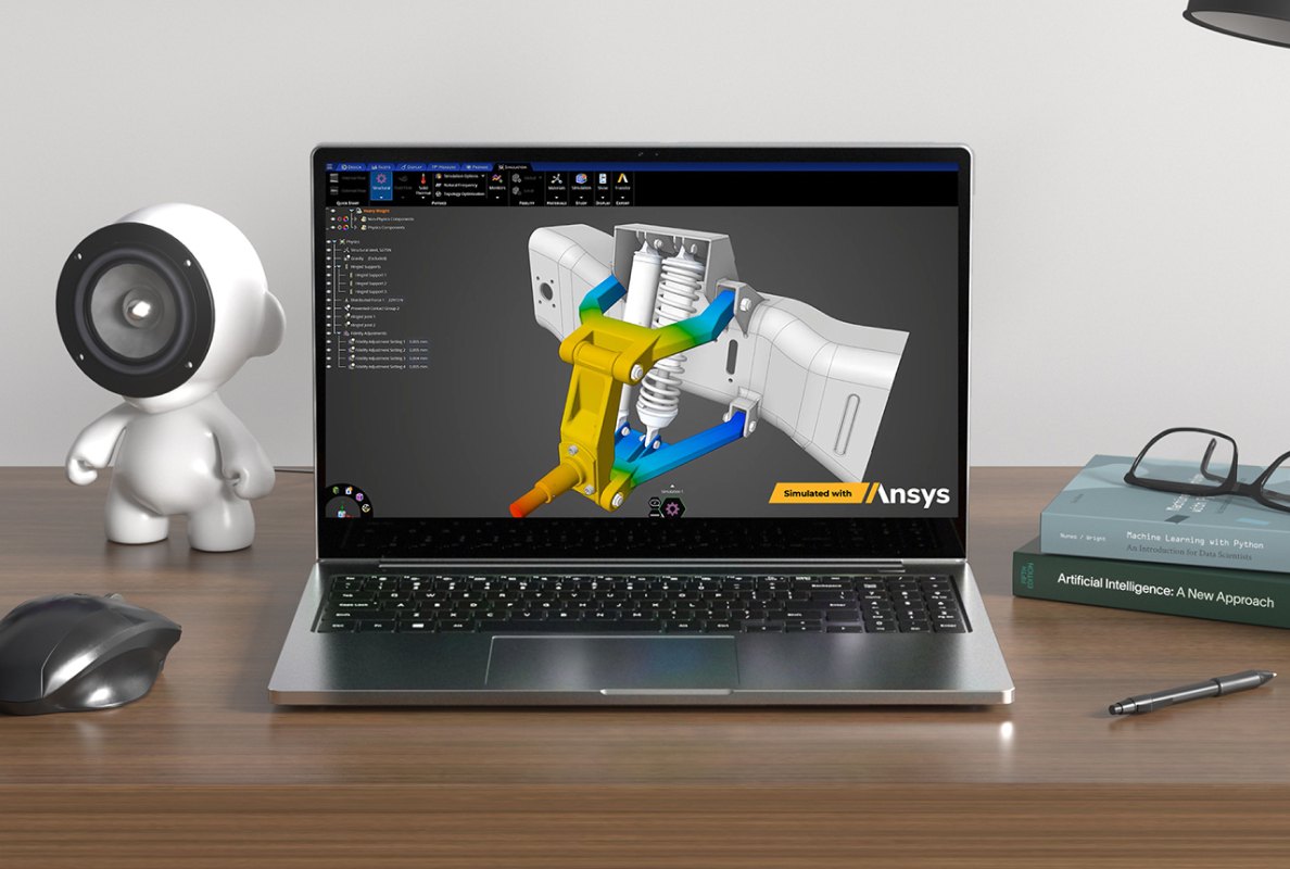 Portátil mostrando simulación de pieza mecánica en amarillo, azul y blanco. Un ratón, un altavoz, libros y un bolígrafo en la mesa.