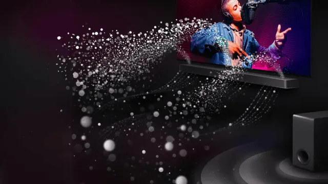 En un fondo negro, una barra de sonido debajo de una pantalla reproduce música, rodeada de puntos blancos, con un subwoofer a la derecha.