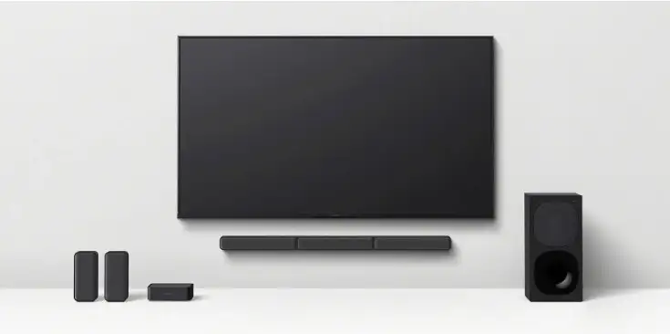 Barra de sonido con subwoofer y altavoces frente a televisor.