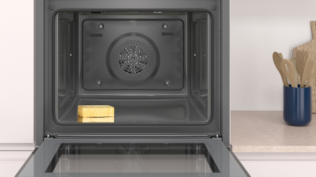 Interior de un horno abierto, con una esponja en su interior para ilustrar la fácil limpieza