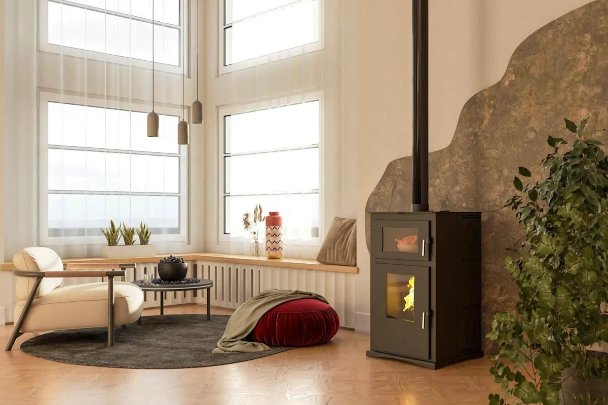 Sala de estar luminosa con estufa de leña, sillón, mesa auxiliar, otomana roja y planta. Ventanas grandes dejan entrar la luz natural.