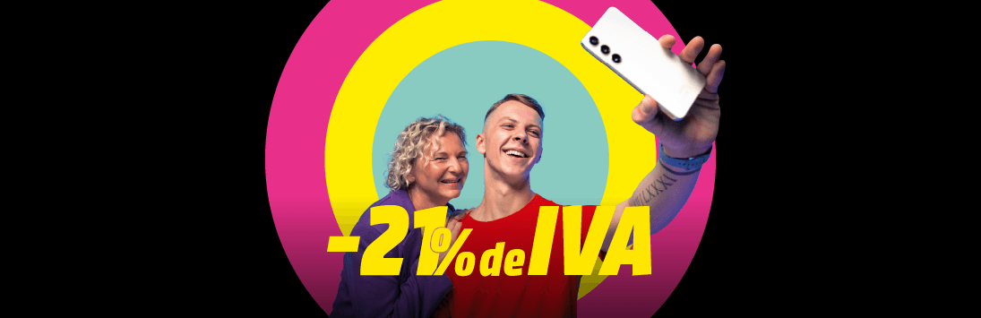 Camiseta roja con texto promocional en amarillo que indica “-21% de IVA”, sostenida por una persona que toma una selfie con un smartphone. Fondo llamativo con círculos concéntricos en colores rosa, amarillo y azul.