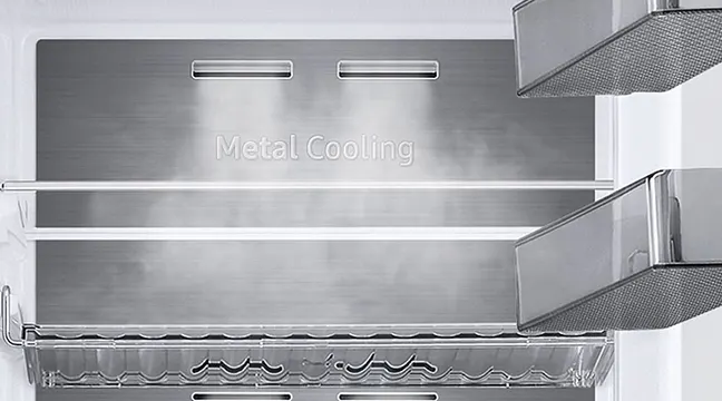 Interior de nevera metálica con estantes y compartimentos visibles. La pared posterior tiene la inscripción "Metal Cooling".