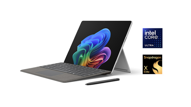 Un ordenador portátil gris muestra una pantalla con un diseño colorido sobre un fondo azul claro con el logo de Microsoft Surface.