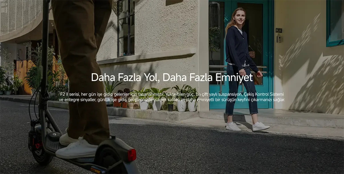 There is a person riding an electric scooter and a woman standing in front of a building with a blue door.