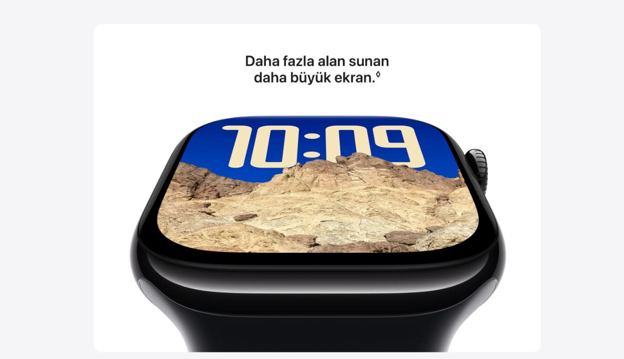 Siyah Apple Watch ekranında 10:09 yazısı ve çöl manzarası var. Üstte "Daha fazla alan sunan daha büyük ekran." yazısı yer alıyor.